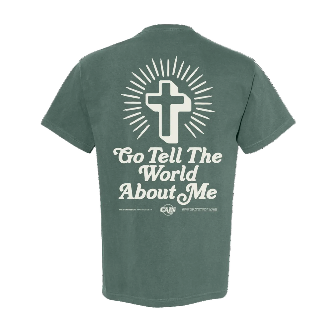 Green t-shirt with a cross and text design on the back against a white background